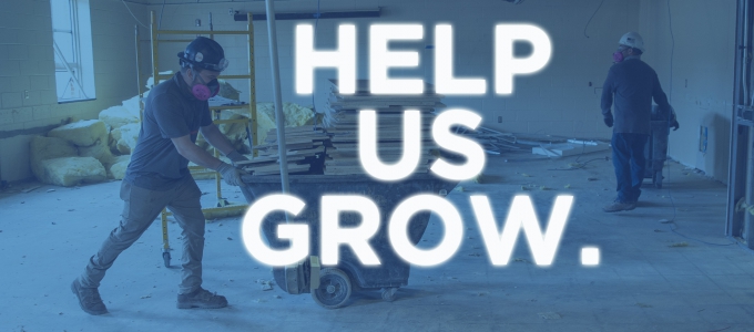 Renovation of a classroom with two workers and the words Help Us Grow over the image.
