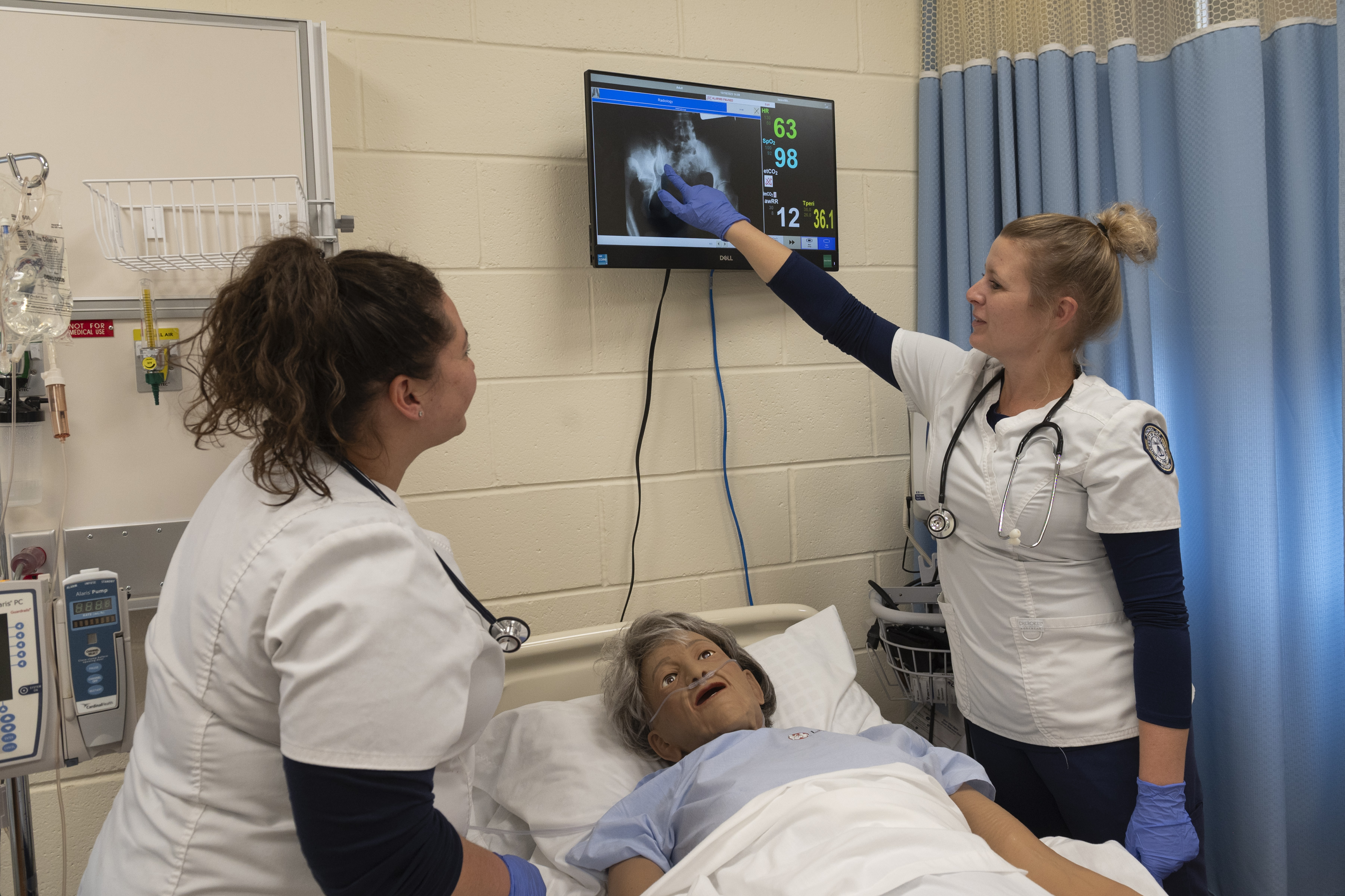 Two nursing students going through a simulation.